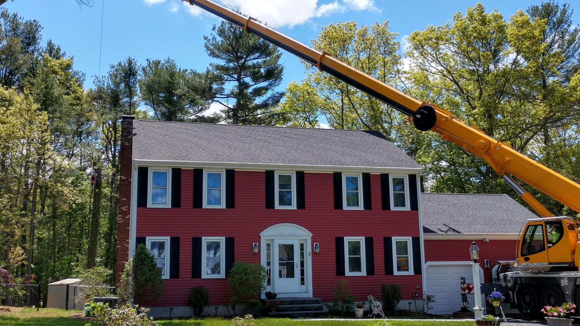 The Regal Tree crane removing a tree near a home in Millis, MA.