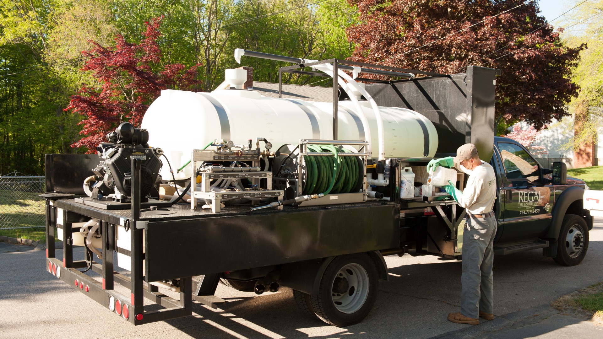 An arborist from Regal Tree preparing fungicides to treat a tree in Sherborn, MA.